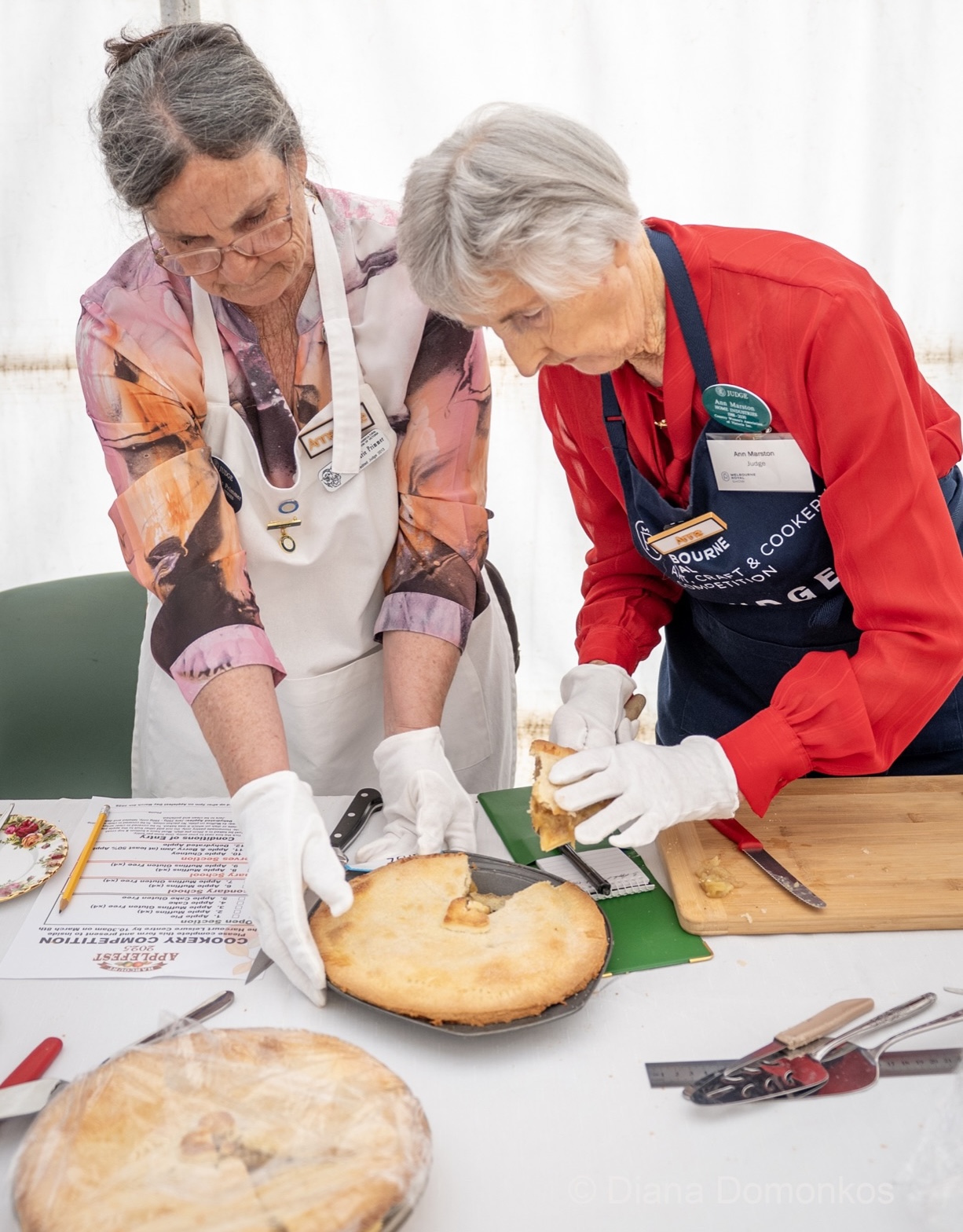 Judges cutting into an apple pie competition entry